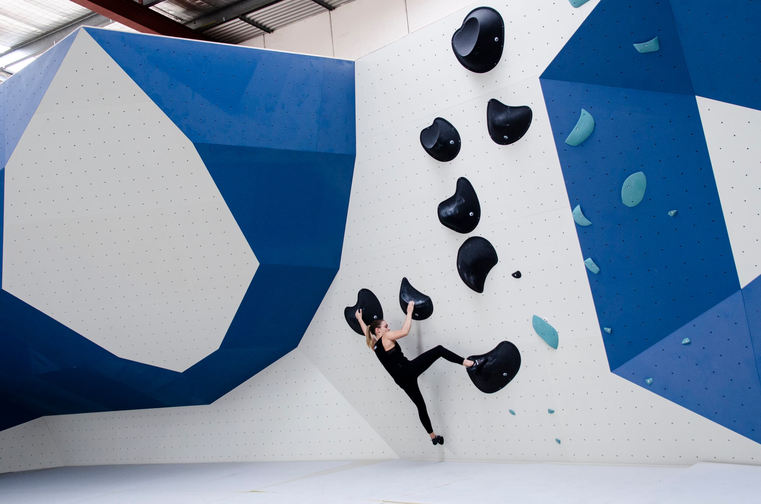 Woman climbing on a Black route at Paramatta