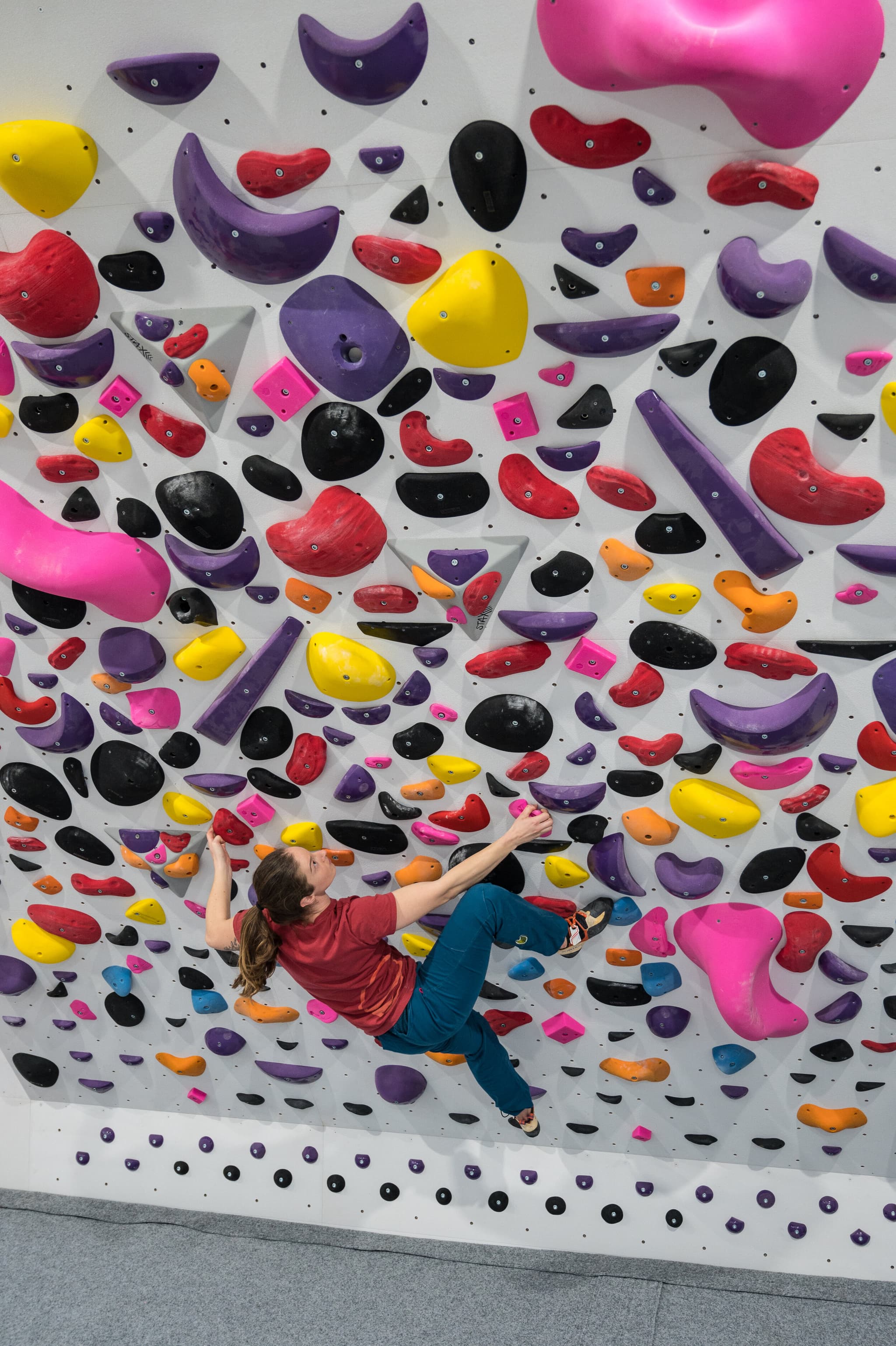 Person climbing colorful rock wall