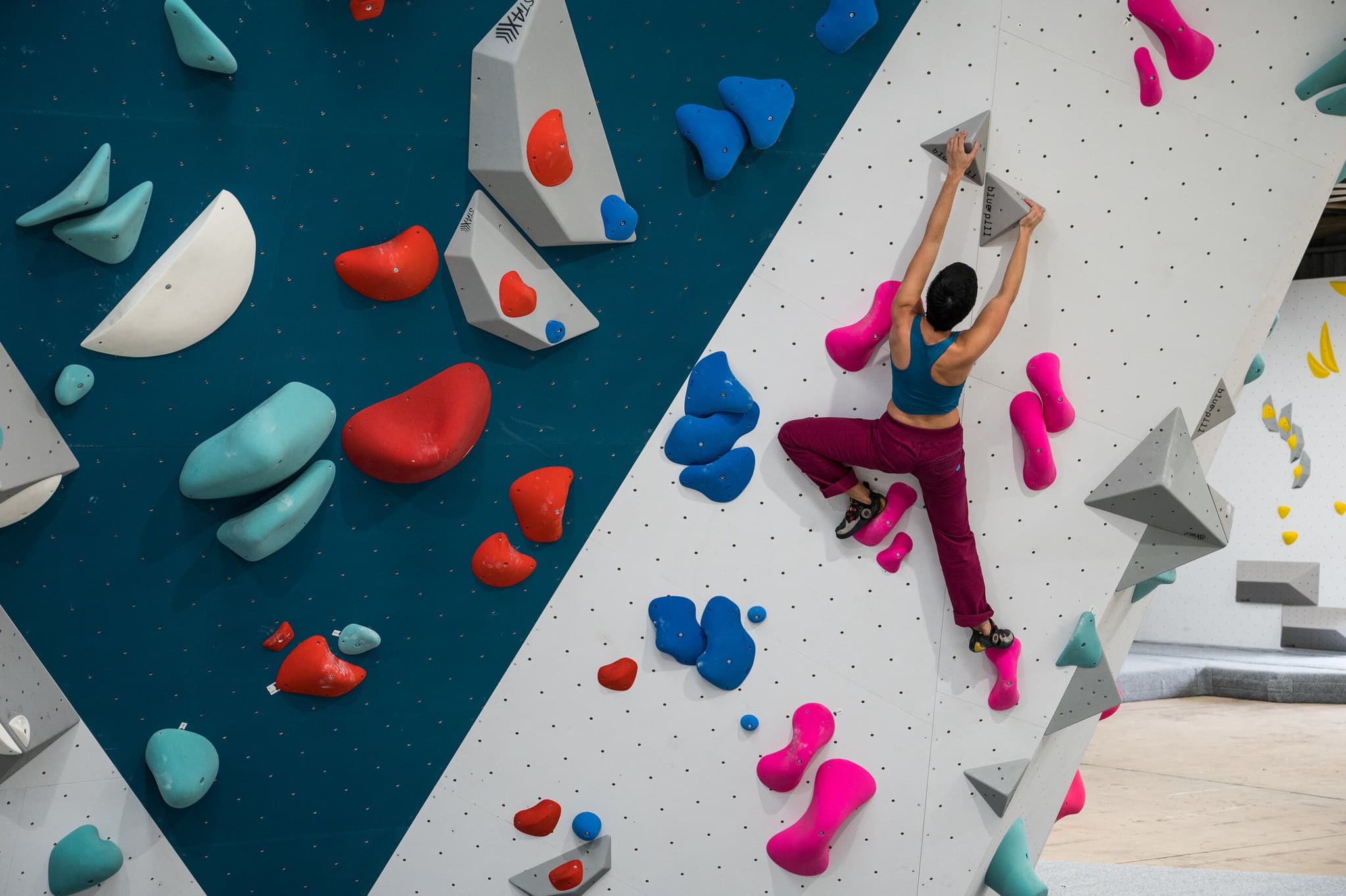 Person climbing colorful rock wall